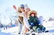 © Kalim - Nice happy family having fun on winter snow