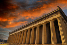 A Stunning Shot Of The The Parthenon In Centennial Park With Tall Brown Stone Pillars Around The Building And Powerful Clouds At Sunset In Nashville Tennessee USA
