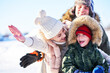 © Kalim - Nice happy family having fun on winter snow