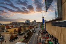 A Gorgeous Shot Of The Autumn Landscape In The City With Glass Buildings With Color Murals And A Green Construction Crane With Powerful Clouds At Sunset  In Nashville Tennessee USA