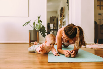 mom doing plank exercises with her baby