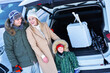 © Kalim - Young family during winter trip car trunk in bacground