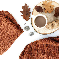 Sticker - Top view of autumn leaves, a coffee with cookies, and a piece of fabric on a white texture