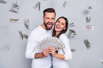 Wall Mural - Photo of hooray young brunet couple win money wear white shirt isolated on grey background