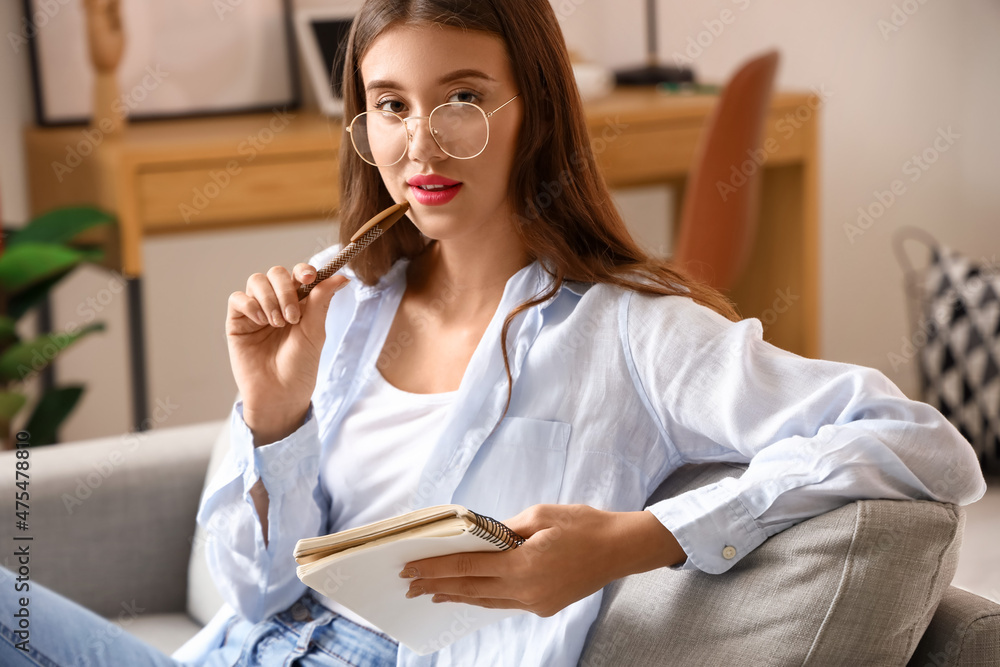 Pretty young woman video chatting at home