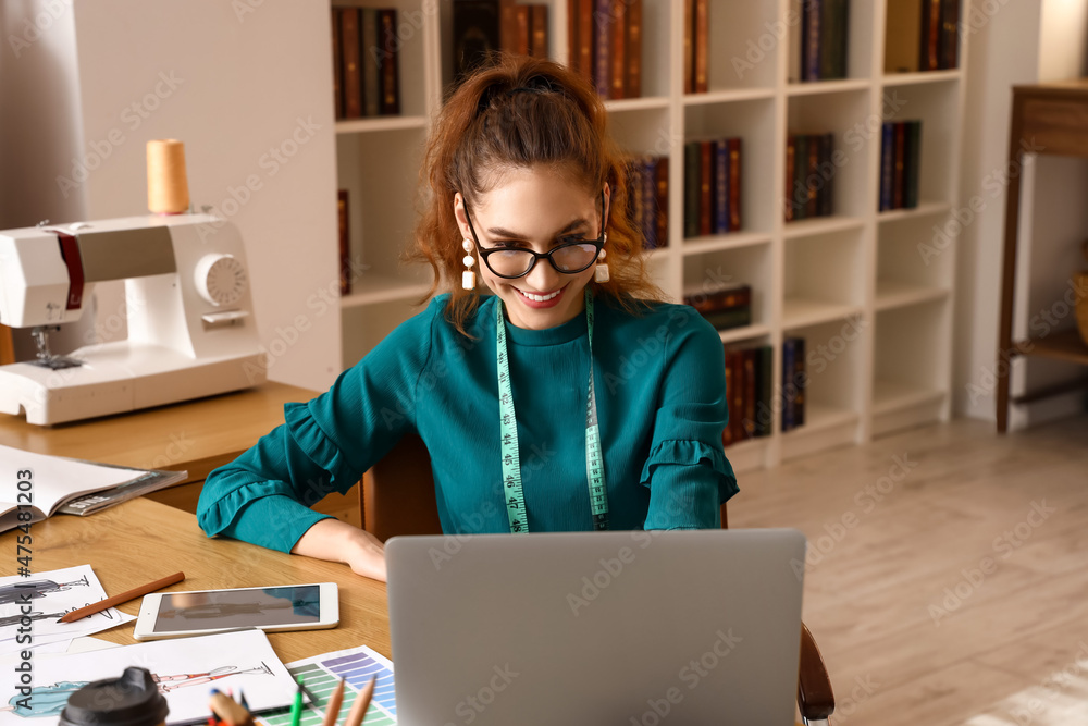Young female clothes stylist working in studio