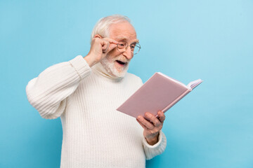 Sticker - Photo of optimistic aged man read book wear spectacles pullover isolated on blue color background