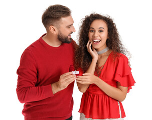 Wall Mural - Young man proposing to his girlfriend on white background