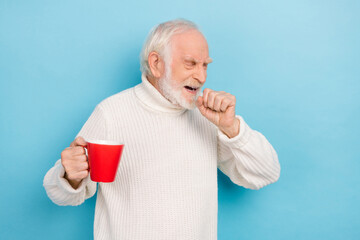 Sticker - Portrait of attractive sick grey-haired man drinking hot tea coughing isolated over bright blue color background