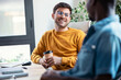 © nenetus - Two graphic designer taking a break while talking and having fun together in modern startup office.