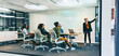 © Jacob Lund - Confident young businesswoman giving a presentation in a boardroom