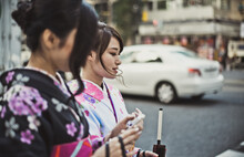 Storytelling Image Of Two Japanese Girls Wearing Kimono Spending Time In Tokyo. Traditional Clothes Lifestyle Moments From The Local Culture In Japan