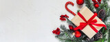 Fototapeta Mapy - Christmas light background. Corner decorated with fir twigs and Christmas baubles. Red berries, candies, gifts, snowflake and fir cone. Top flat view with text copy-space.