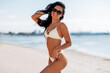 © Syda Productions - people, summer and swimwear concept - happy smiling young woman in bikini swimsuit on beach