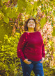 © T.Den_Team - Chubby sunny woman in warm casual clothes in city park. Clothes for plus size ladies