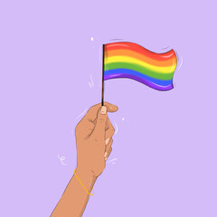 hand holding a rainbow flag