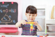 © M-image - young  girl  play magical magnet experiments at home for homeschooling