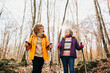 © Jordi Salas - Two senior female friends hiking together through the forest in autumn