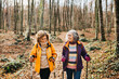 © Jordi Salas - Two senior female friends hiking together through the forest in autumn
