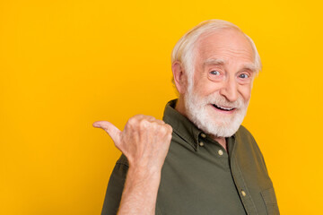 Sticker - Profile photo of cheerful aged person indicate thumb empty space isolated on yellow color background