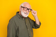 © deagreez - Profile photo of candid satisfied aged man arm touch glasses look camera isolated on yellow color background