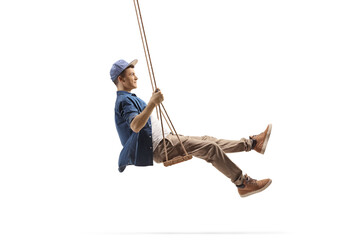 Poster - Profile shot of a young man swinging on a wooden swing