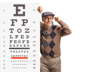 Poster - Elderly man wearing glasses and standing next to a vision exam