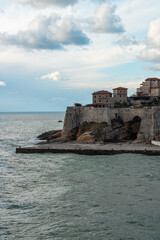 Canvas Print - Beautiful shot of the old town of Ulcinj and the Adriatic sea under a blue cloudy sky