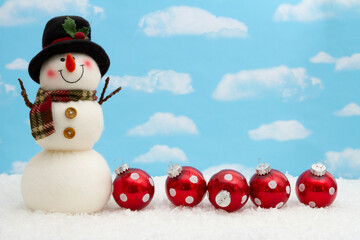 Wall Mural - Happy snowman with hat, ornaments, and snow with sky