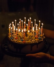 Anniversary Cake With Burning Candles On Dark Background