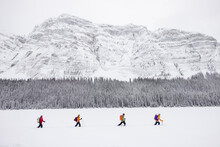 Friends Skiing Below Majestic Snow Covered Canadian Rocky Mountains