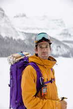 Portrait Confident Male Skier With Backpack And Walkie Talkie In Snow