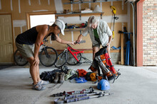 Active Senior Couple Preparing Trekking Equipment In Garage