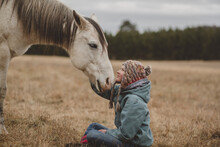 Teen Girl Touching Horse Head Tenderly