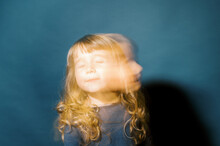 Portrait Of A Little Toddler Girl In Golden Light With Slow Shutter