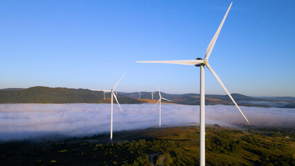 Wind farm in the morning fog. Aerial photography