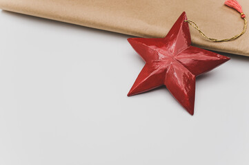 Poster - red wooden star Christmas decoration on a white and brown paper background