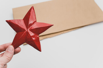 Poster - red wooden star Christmas decoration on a white and brown paper background