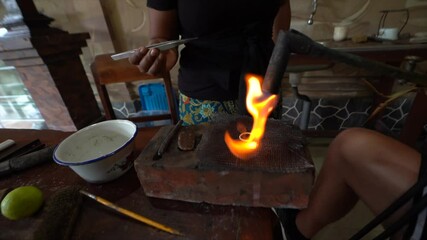 Sticker - A Process of melting a Silver ring on a gas fire