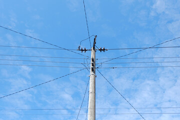 Poster - Electrical power pole with many cables connecting to it with blue sky on the background