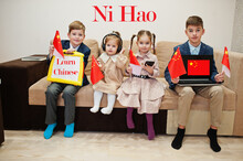 Four Kids Show Inscription Learn Chinese. Foreign Language Learning Concept. Ni Hao.