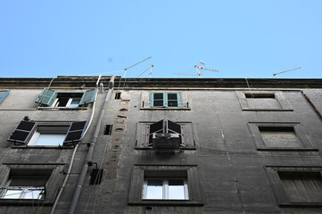 Wall Mural - Low angle view of an old building against a blue sky in Rome, Italy