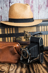 Vintage suitcase, hat and old camera