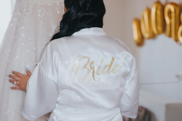 Poster - Bride wearing a white robe and getting prepared for the wedding in the morning