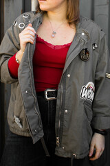 Canvas Print - Vertical shot of a female wearing a casual coat over a red blouse