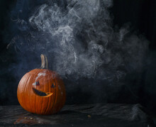 Carved Halloween Pumpkin With Smoke Coming Out Of Holes