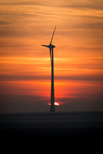 Serene View Of A Silhouette Of A Windmill On A Red Sky At Golden Sunset