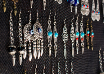 Sticker - Close-up shot of earrings hanging on a jewelry stand