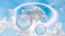 Soap Bubbles Floating In The Air With Rainbow - Blowing Big Soap Bubbles In The Air Against Blue Cloudy Sky