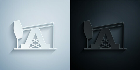 Paper cut Oil pump or pump jack icon isolated on grey and black background. Oil rig. Paper art style. Vector